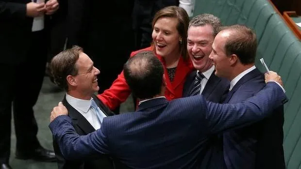 Australia's Coalition Members of Parliament celebrating the carbon repeal bills passing the House of Representatives.