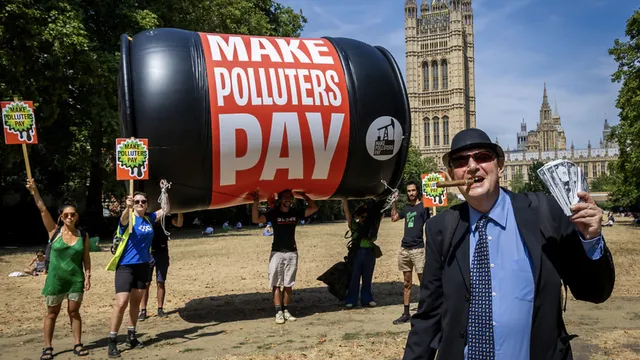 The Make Polluters Pay coalition calling on the British government for a greater taxation of the fossil fuel industry to pay for climate damage outside the UK Houses of Parliament on 3 August 2026.