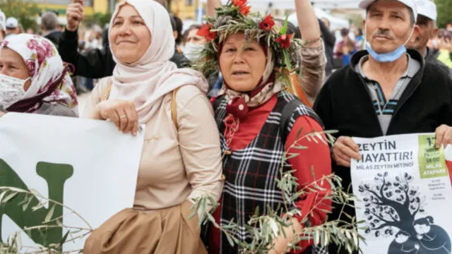 Locals in a march holding posters to protect olive trees