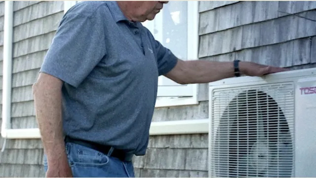 Man in front of a heat pump in Canada.