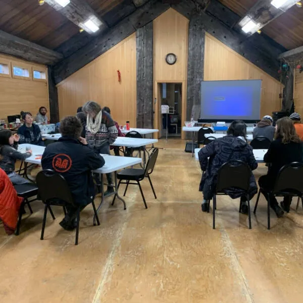 Toxic Trivia game in a large hall, people sitting at different tables playing