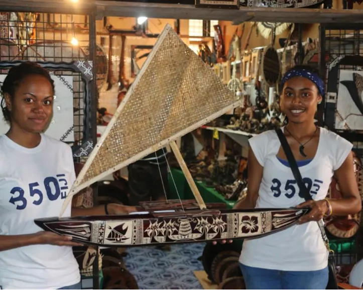 350 Fiji Volunteers with a model of a traditional canoe