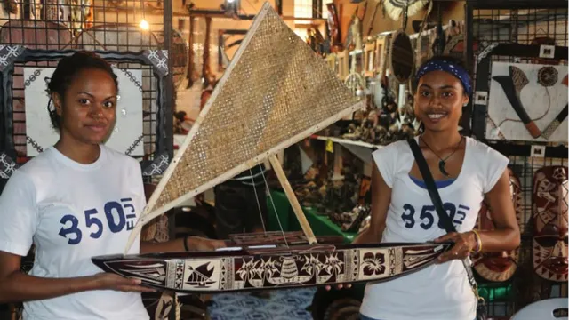 350 Fiji Volunteers with a model of a traditional canoe