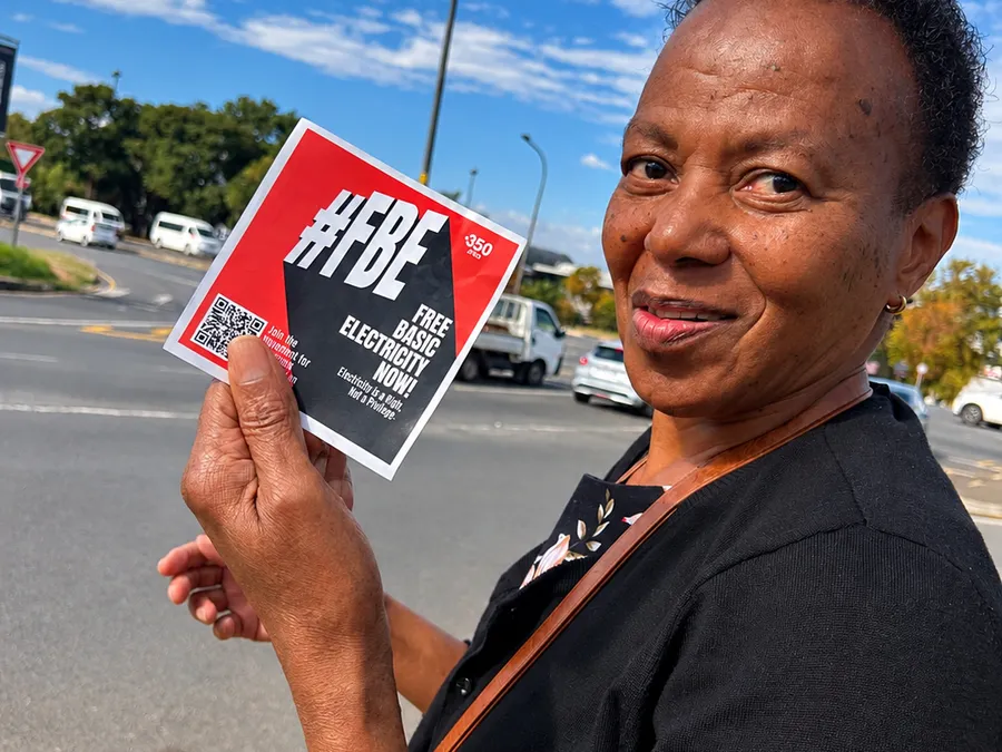 Woman Holding Electricity Rights Flyer