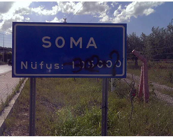 Photo by Cansın Leylim Ilgaz. “SOMA Population 105000” Above which, “-302?” has been graffitied.