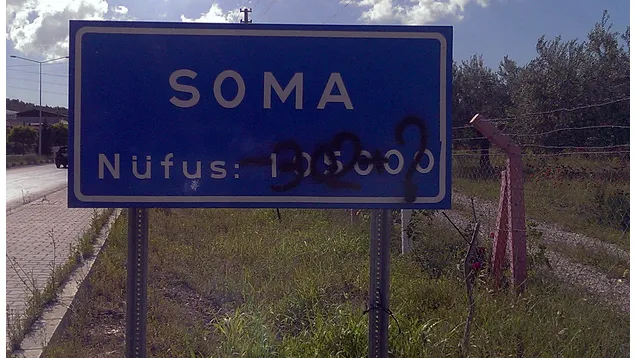 Photo by Cansın Leylim Ilgaz. “SOMA Population 105000” Above which, “-302?” has been graffitied.