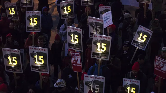 Demonstrators rally to raise the hourly minimum wage to $15 for fast-food workers at City Hall in Seattle