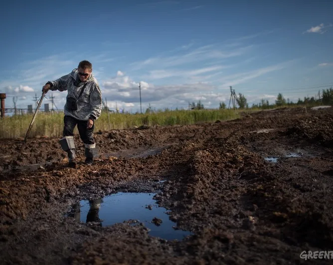 Sergey Kechimov shows the traces the oil companies left on Khanty land - courtesy Denis Sinyakov, Greenpeace 