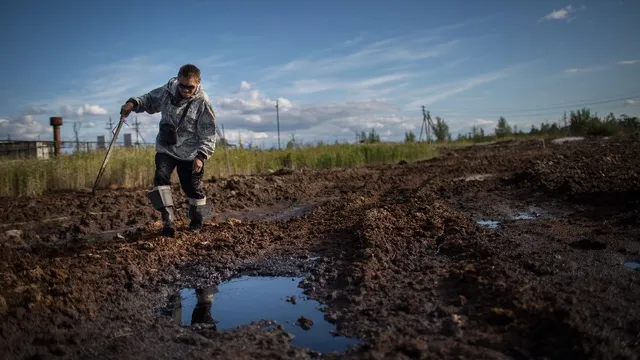 Sergey Kechimov shows the traces the oil companies left on Khanty land - courtesy Denis Sinyakov, Greenpeace 