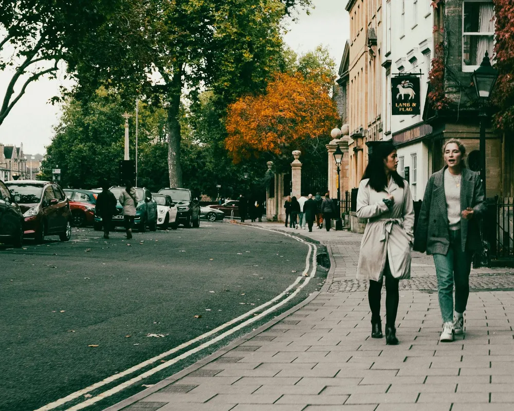 two women walking along a street, talking climate