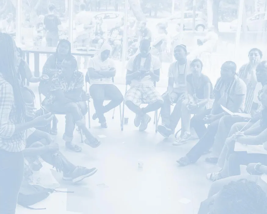 Group sitting around in a circle with facilitator