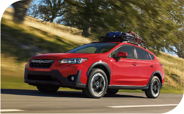 red Crosstrek traveling safely up the highway.