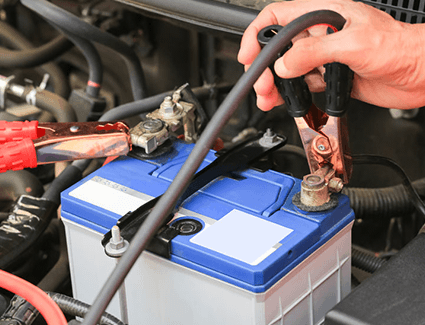 Jumper cables attached to car battery