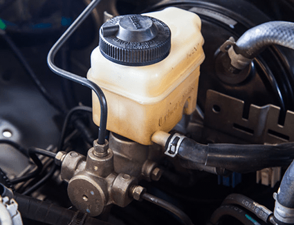 Most of the brake system is found at the wheels, but hydraulic pressure comes from the brake master cylinder under the hood