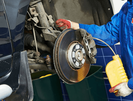A technician drains the old brake fluid from the brake lines, before adding fresh fluid for superior stopping performance