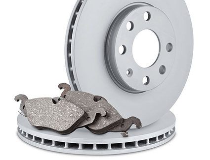 A set of new brake rotors and fresh brake pads are waiting to be installed