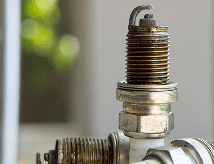 Three spark plugs removed from a vehicle