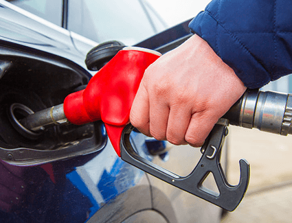 A person fills their car with fuel.