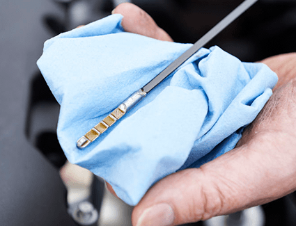 Person checking oil dipstick