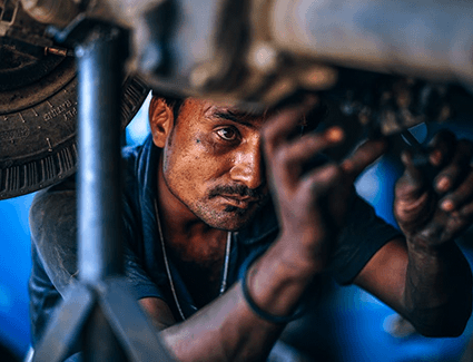 A person works on a vehicle.