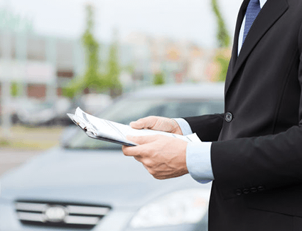 Person looking at documents on a clipboard