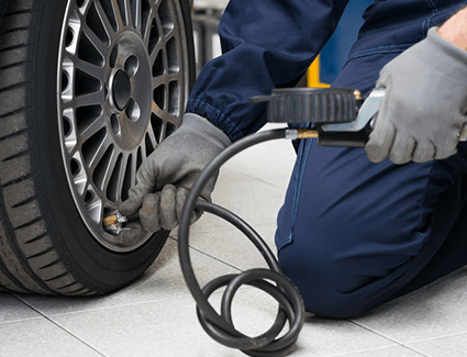 Person checking tire's air pressure