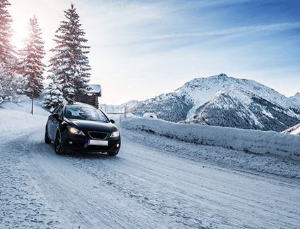 Car traveling on snow-covered road
