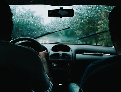 Inside view through windshield of car driving in rain