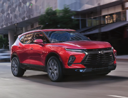 Photograph of a 
red 2026 Chevrolet Blazer driving in a city
