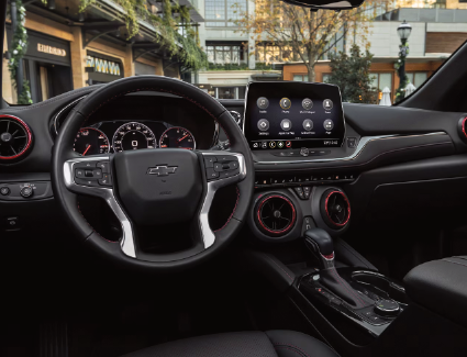 Photograph of the
steering wheel, instrument cluster, and center console of a 2026 
Chevrolet Blazer