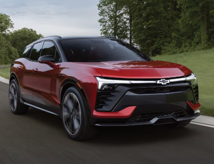 Photograph of a 
red 2026 Chevrolet Blazer parked outside a city shop.