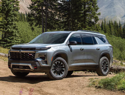 Front and side view of a 2026 Chevrolet Traverse parked on a trail.