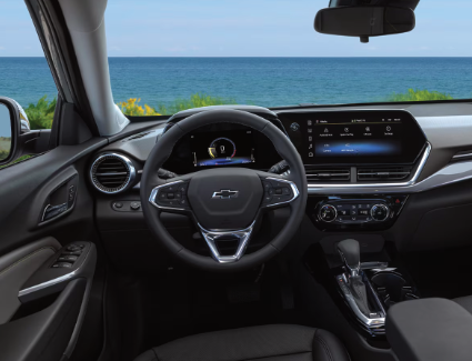 Photograph of the front seats, steering wheel, dashboard, and center console of the new 2026 Chevrolet Trax