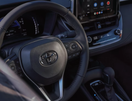 The steering wheel and console on the new 2026 Toyota Corolla, shown in Black premium fabric trim.