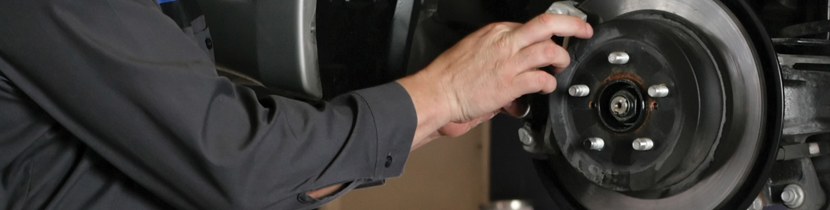 Photograph of a Person Removing a Brake Caliper