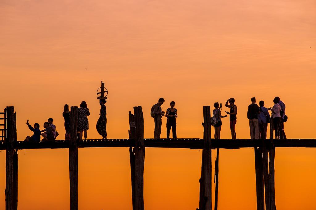 people enjoy sunset on U Bein bridge, Mandalay