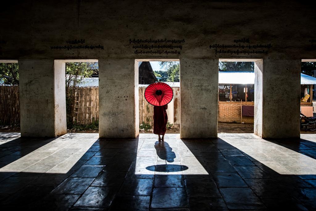 Monk with a red umbrella