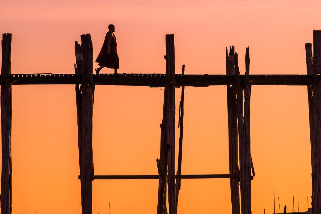man walking on U Bein bridge, Mandalay