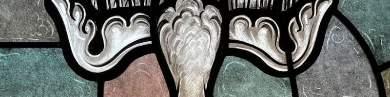 a stained glass window with a bird on it