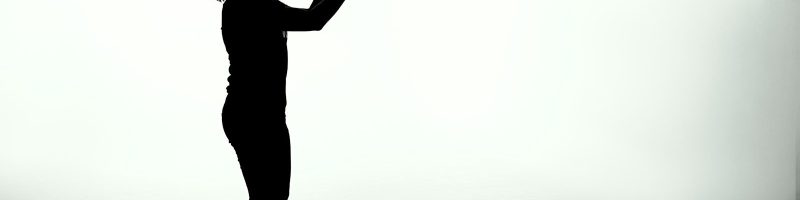 silhouette of woman holding rectangular board