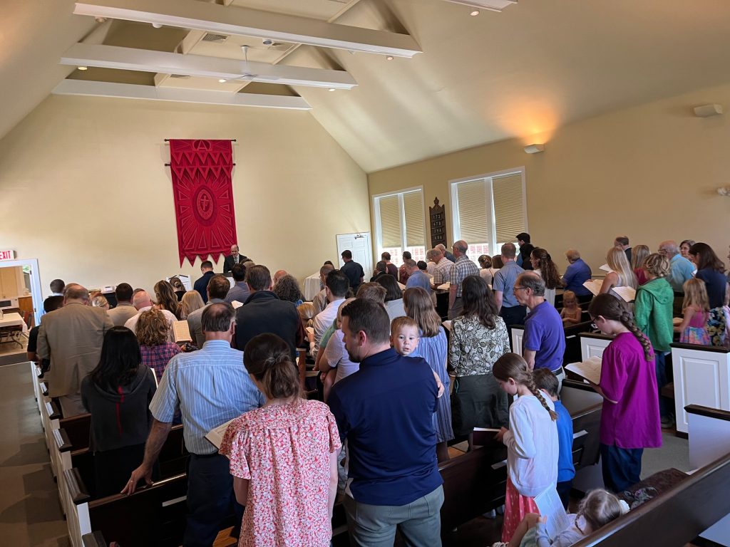 Grace OPC congregation standing to sing during worship