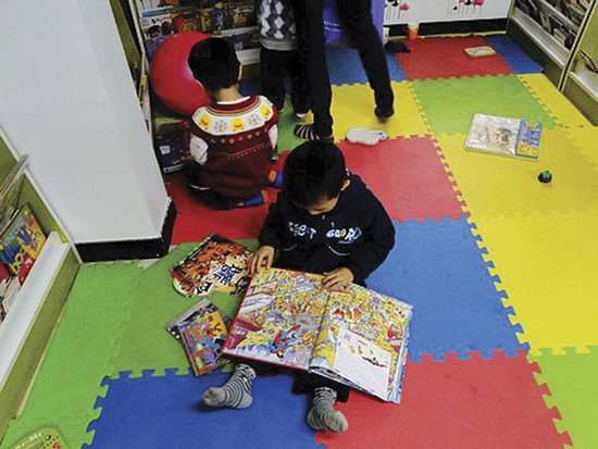 Engrossed in a book at the Happy-Start English-Language Children's Library, Beijing. Photo courtesy Minjie Chen.