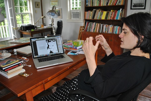 Nora is showing me the process of creating Photoshop files for silkscreen printing.