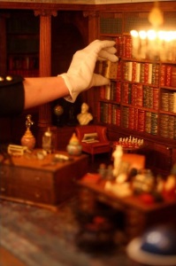 queen mary's dollhouse library with hand