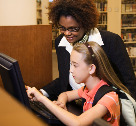 Librarian and student using the computer