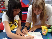 Huyen-Yen and TAB President, Haley Christensen, do some teamwork coloring during a Random Club program