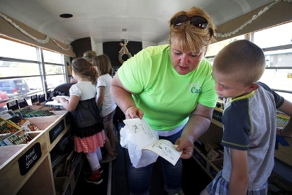 Librarian Jenny Granger helps a student find a book. Snohomish Book Café