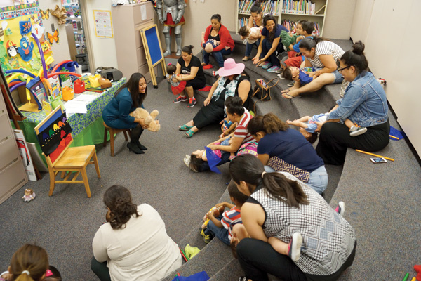 Silvia Cisneros leads bilingual storytime for babies at the Santa Ana (CA) Public Library. Photo by David Lopez/Courtesy of Santa Ana Public Library