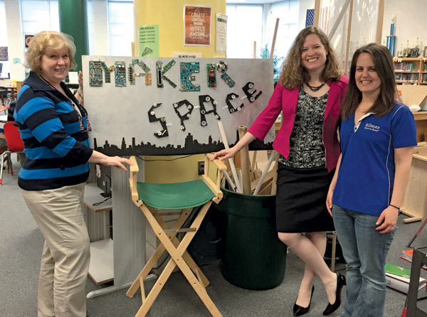 Kilmer Middle School librarians and Priscille Dando (center) with a sign an eighth grader created from VHS cassette plastic and other materials. Photo courtesy of Fairfax (VA) County Public Schools.
