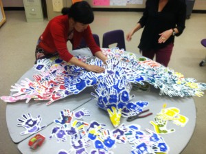 Kathryn Otoshi assembling a Spirit Bird from the many handprints.